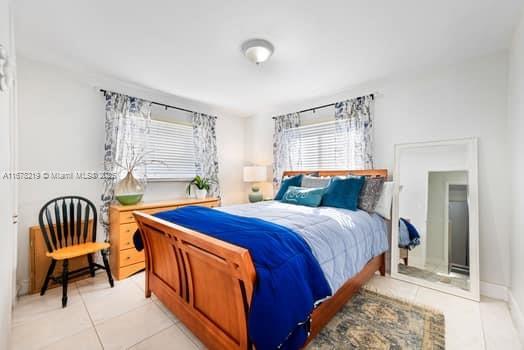 bedroom with light tile patterned floors