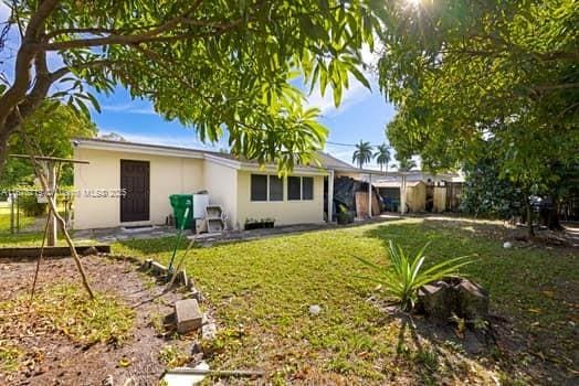 back of house with a lawn