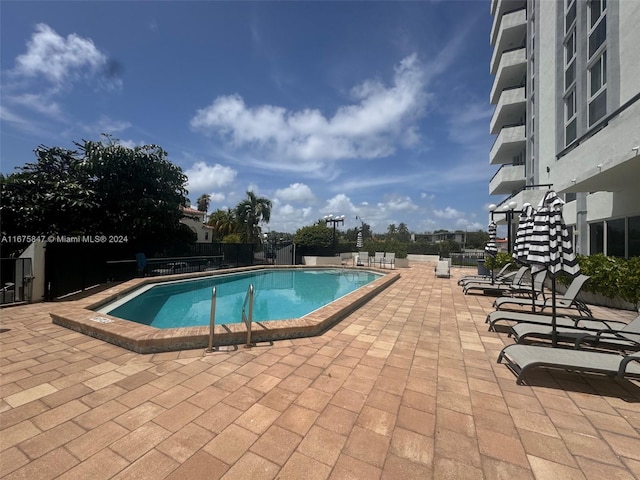 view of swimming pool with a patio area