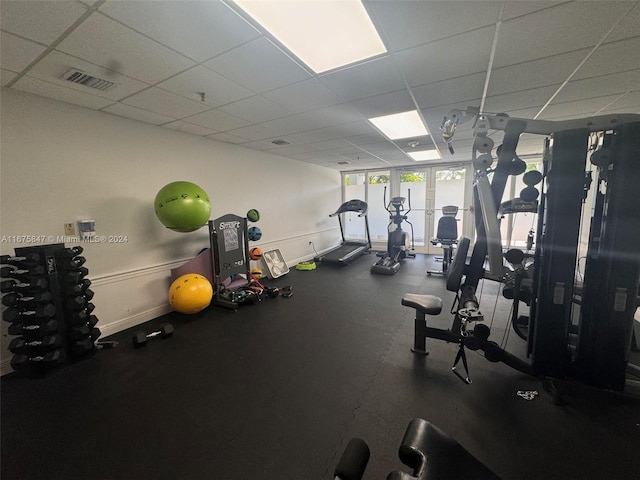 exercise room with a drop ceiling