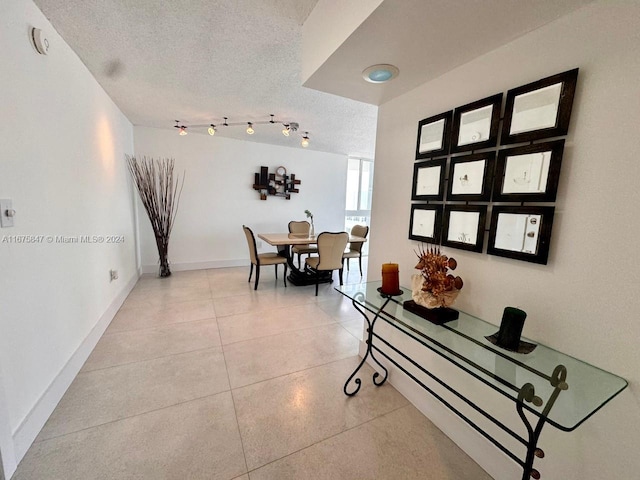 hall featuring a textured ceiling