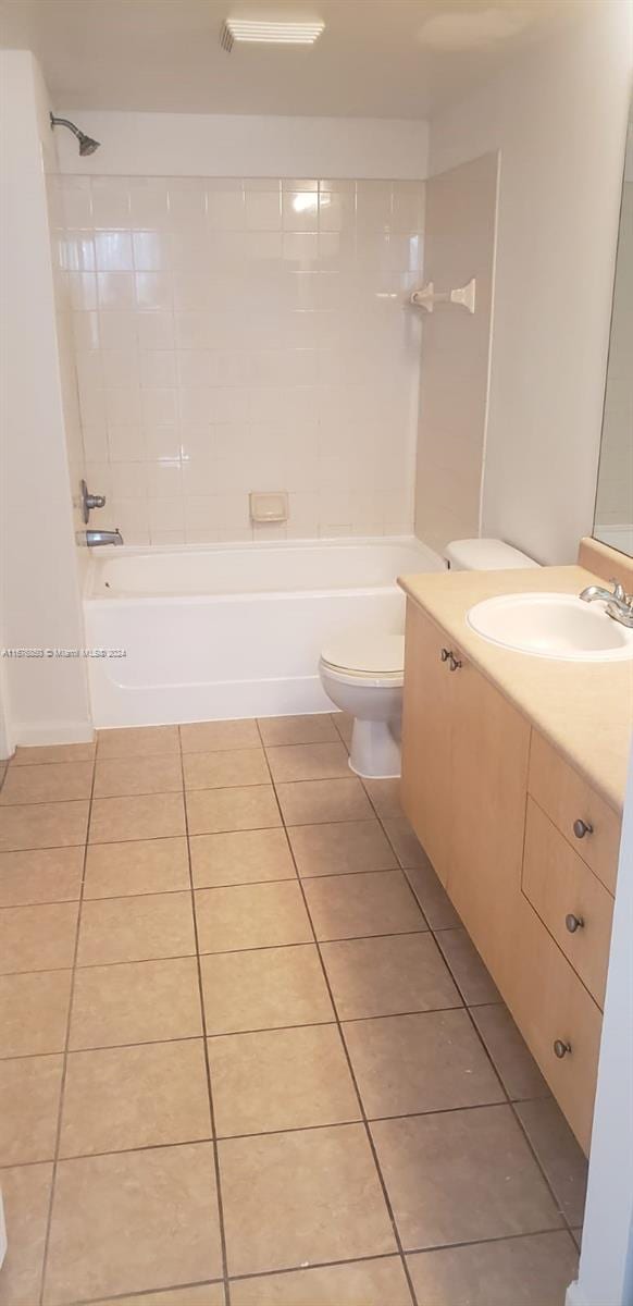 bathroom with tile patterned floors, toilet, bathtub / shower combination, and vanity