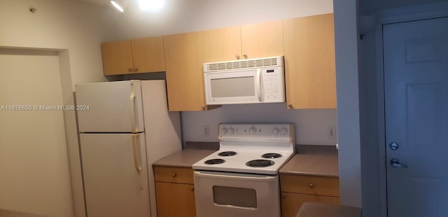 kitchen with light brown cabinetry and white appliances