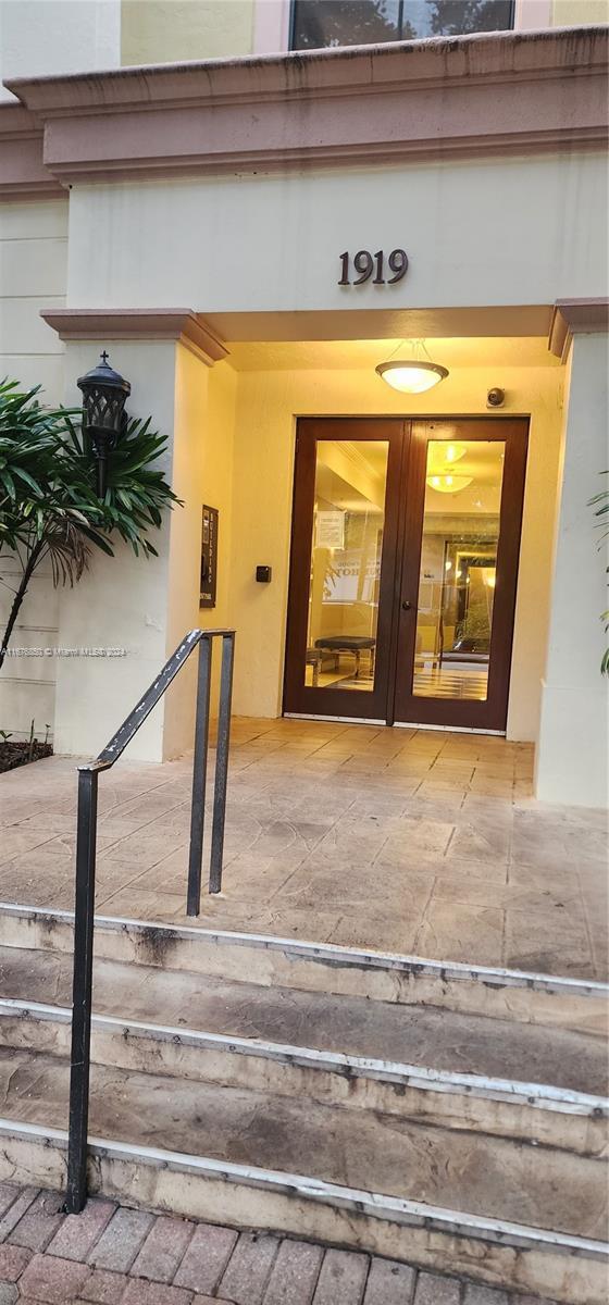 entrance to property featuring stucco siding