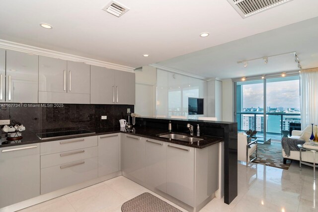 kitchen with stainless steel built in fridge, kitchen peninsula, a breakfast bar, crown molding, and gray cabinets