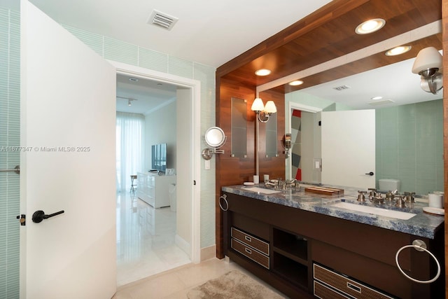 bathroom featuring toilet, vanity, and tile patterned flooring