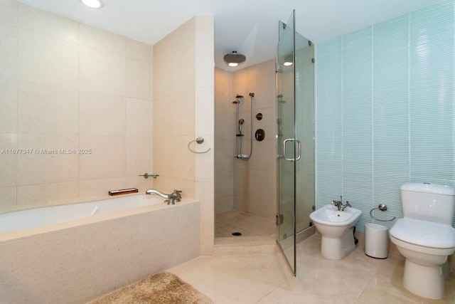 bathroom with tile walls, a bidet, shower with separate bathtub, and tile patterned floors