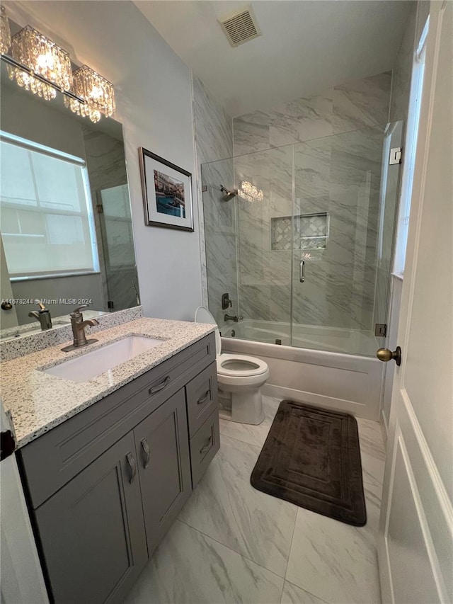 full bathroom with toilet, combined bath / shower with glass door, vanity, and an inviting chandelier