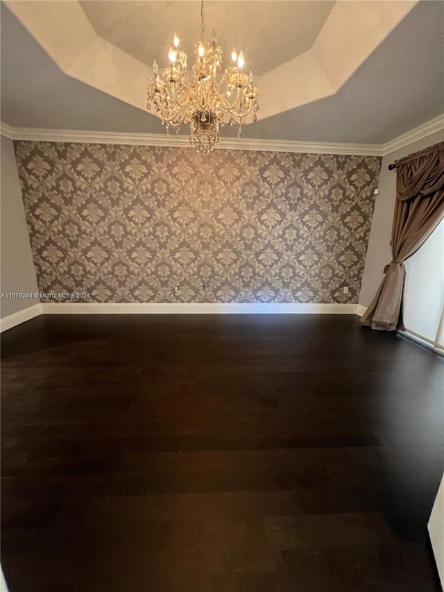 interior space with crown molding, dark hardwood / wood-style floors, a chandelier, and a tray ceiling