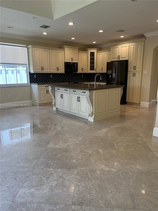 kitchen featuring tasteful backsplash, a center island with sink, black appliances, crown molding, and sink