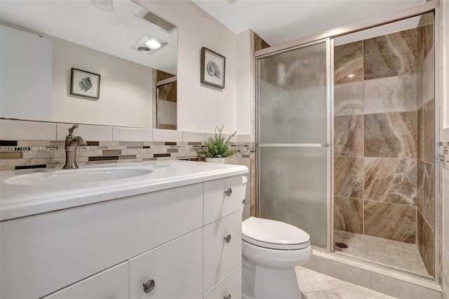 bathroom with vanity, tile patterned flooring, toilet, and an enclosed shower