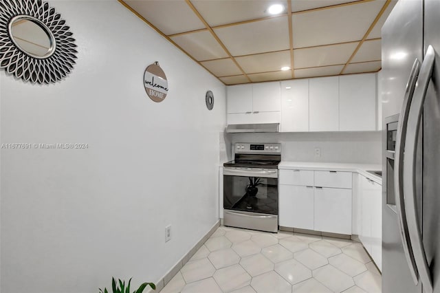 kitchen featuring exhaust hood, white cabinetry, a drop ceiling, and stainless steel appliances