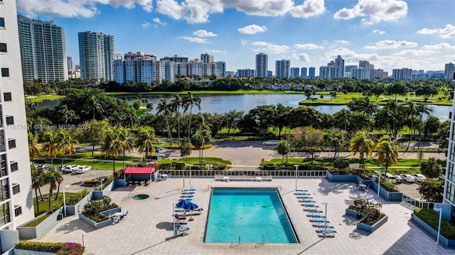 view of pool with a water view and a patio area