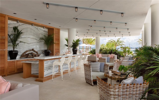 view of patio / terrace featuring exterior bar and an outdoor hangout area