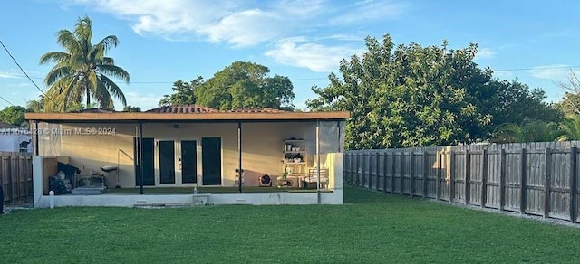 rear view of property featuring a yard