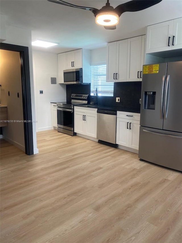 kitchen with white cabinetry, light hardwood / wood-style flooring, and stainless steel appliances