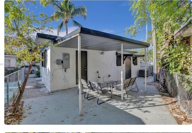 back of property with a patio and central AC unit