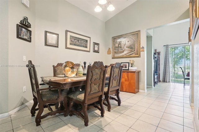 dining area featuring an inviting chandelier, lofted ceiling, light tile patterned floors, and baseboards