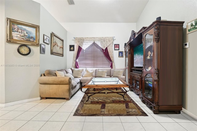 living room featuring light tile patterned floors, visible vents, and baseboards