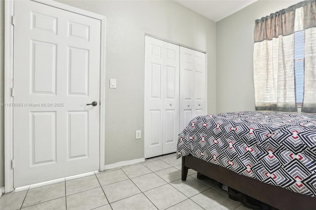 bedroom featuring light tile patterned floors and a closet