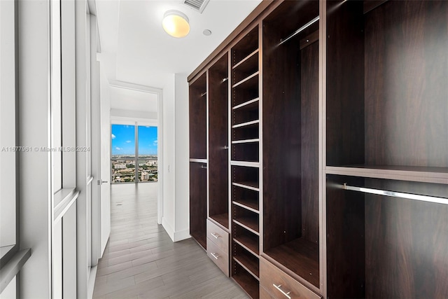 walk in closet featuring light hardwood / wood-style floors