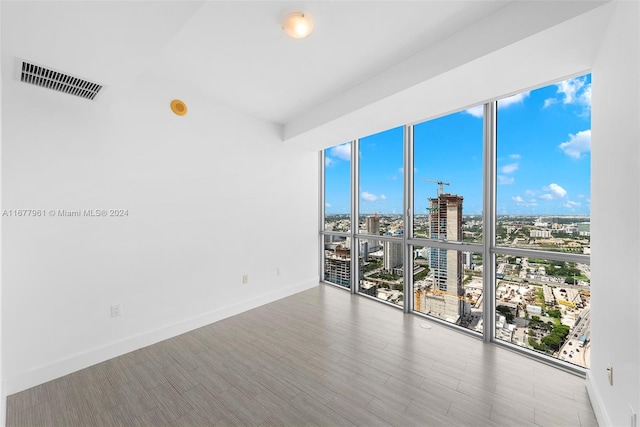 unfurnished room featuring hardwood / wood-style floors