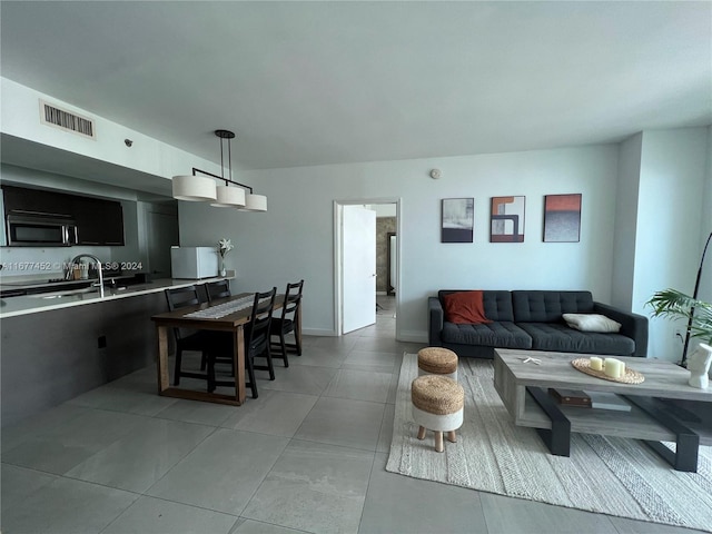 tiled living room featuring sink