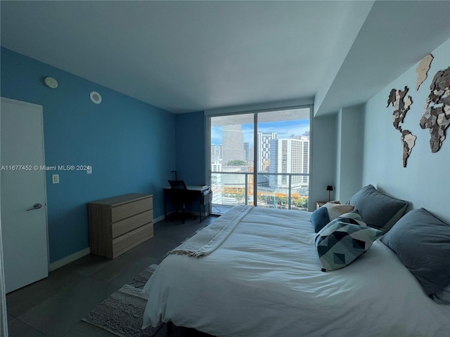 bedroom featuring a view of city and baseboards