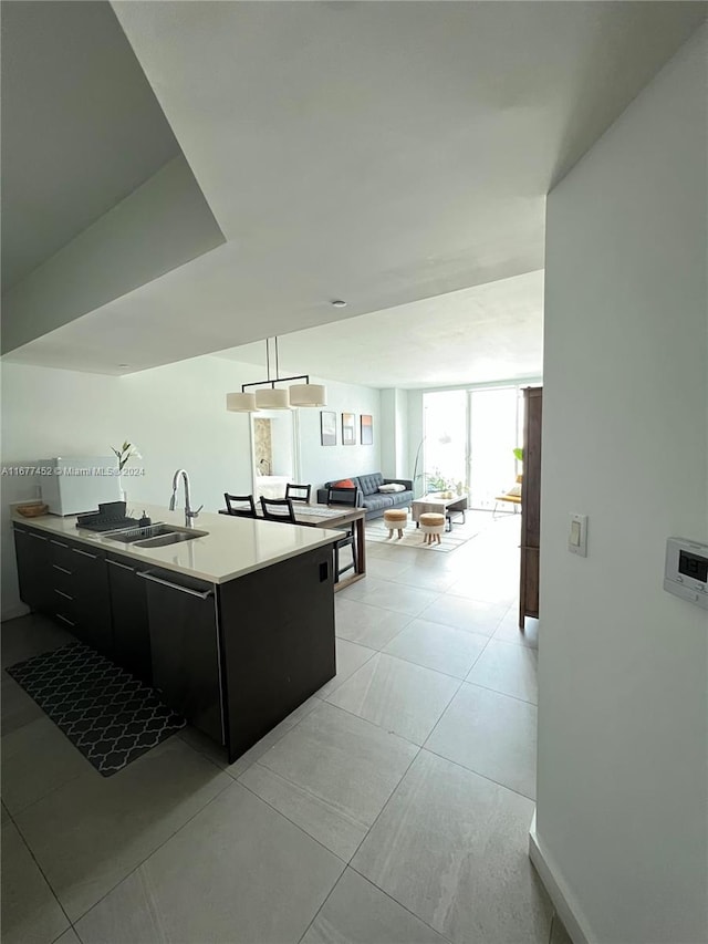 kitchen featuring decorative light fixtures, sink, and floor to ceiling windows