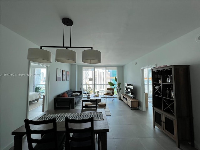 tiled dining space featuring plenty of natural light