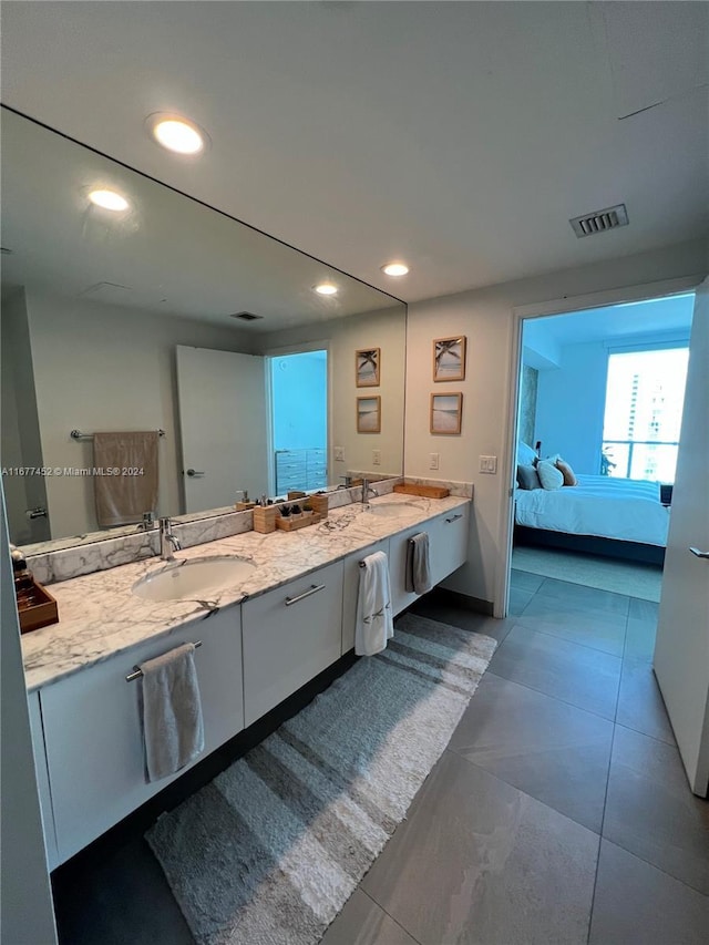 bathroom featuring connected bathroom, a sink, double vanity, recessed lighting, and visible vents