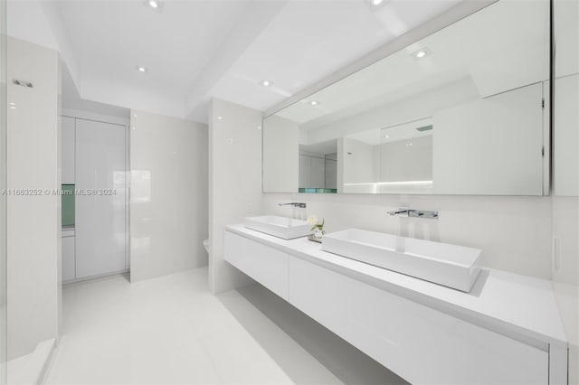 bathroom featuring vanity, toilet, walk in shower, and tile patterned flooring