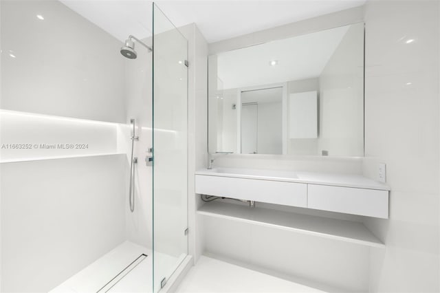 bathroom featuring vanity and tiled shower