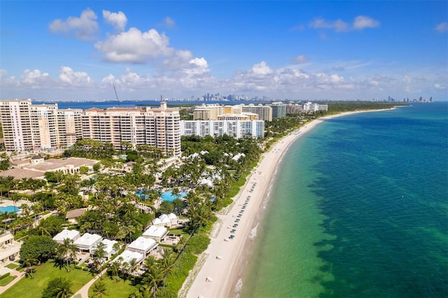 drone / aerial view featuring a water view and a view of the beach