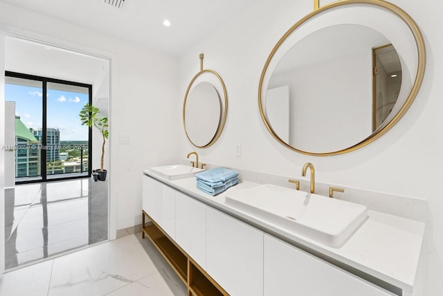 bathroom featuring double vanity, recessed lighting, marble finish floor, and a sink