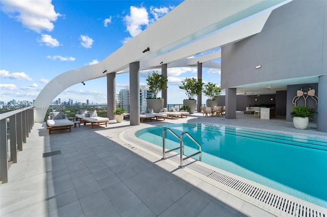 pool with a view of city and a patio area