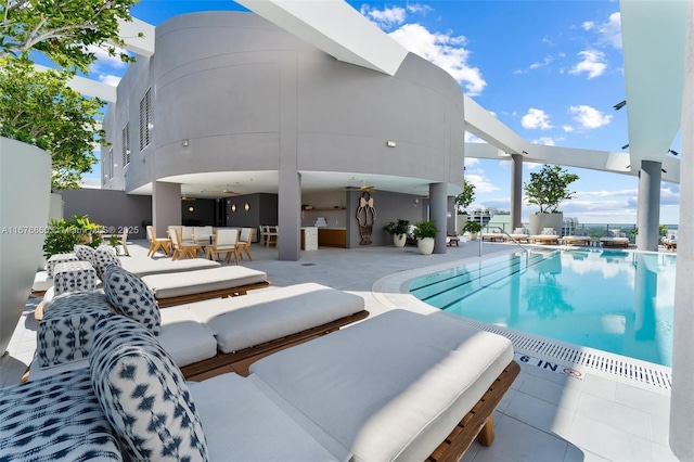 outdoor pool featuring an outdoor living space and a patio