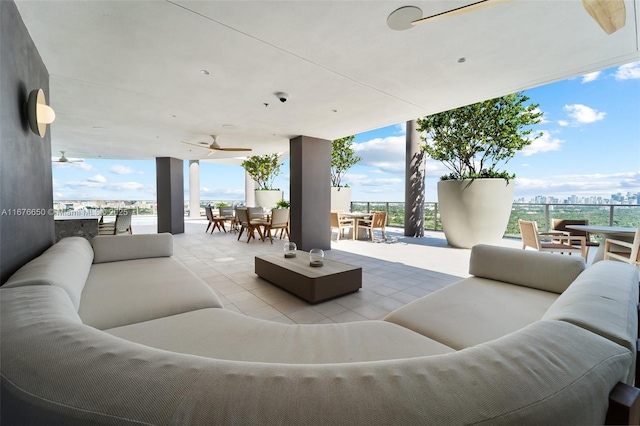 view of patio / terrace with an outdoor living space, outdoor dining space, and a ceiling fan