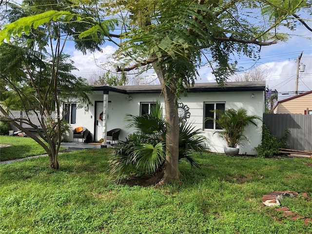 rear view of house featuring a yard