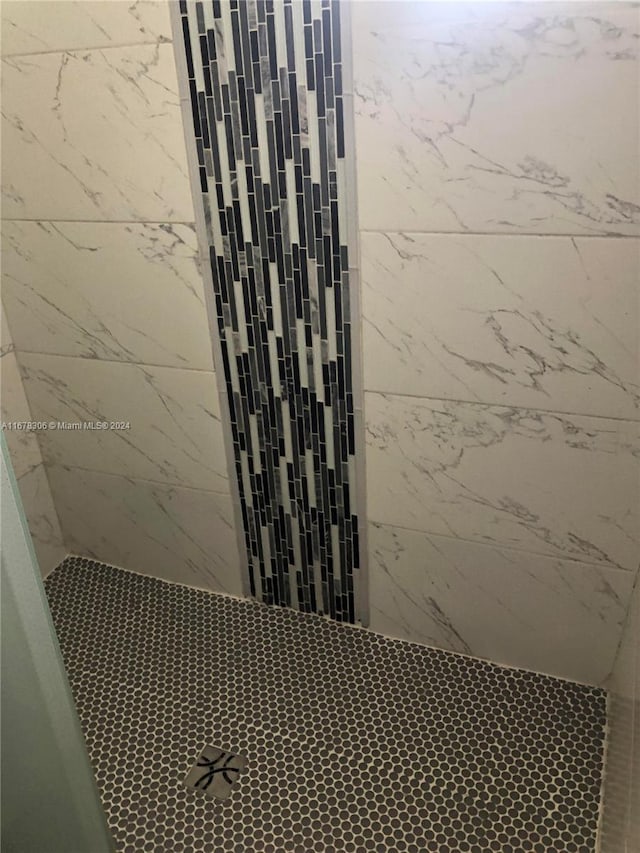 bathroom with a tile shower