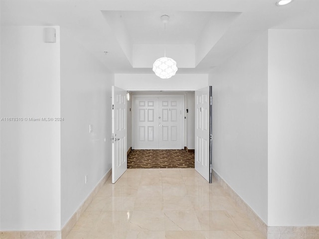 hallway with a tray ceiling