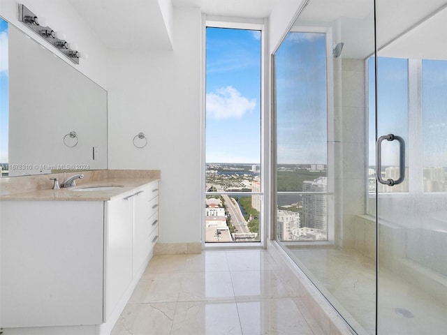 bathroom with a shower with door and vanity