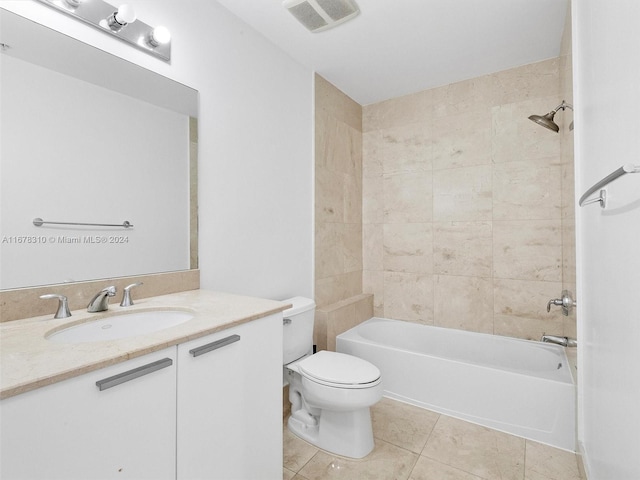 full bathroom featuring toilet, tiled shower / bath, vanity, and tile patterned floors