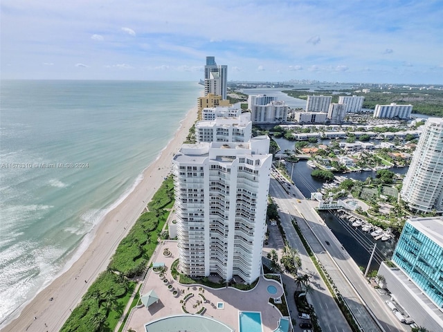 drone / aerial view with a water view and a beach view