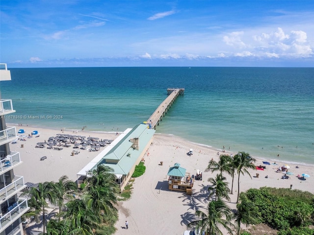 bird's eye view featuring a water view and a beach view