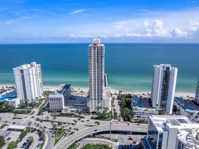 birds eye view of property with a water view and a view of the beach