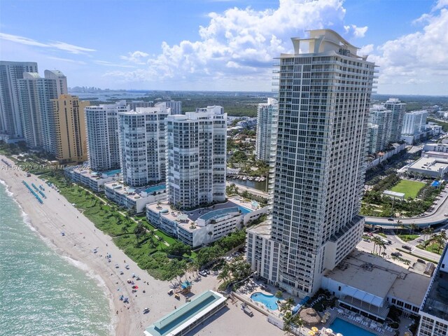 birds eye view of property featuring a view of the beach and a water view