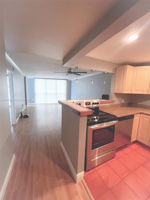 kitchen with appliances with stainless steel finishes, kitchen peninsula, light hardwood / wood-style floors, ceiling fan, and beam ceiling