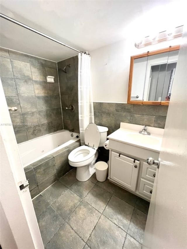 full bathroom with vanity, toilet, and shower / tub combo