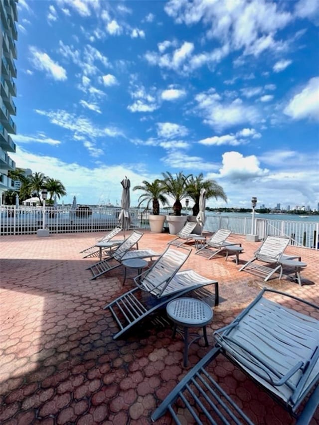 view of patio with a water view